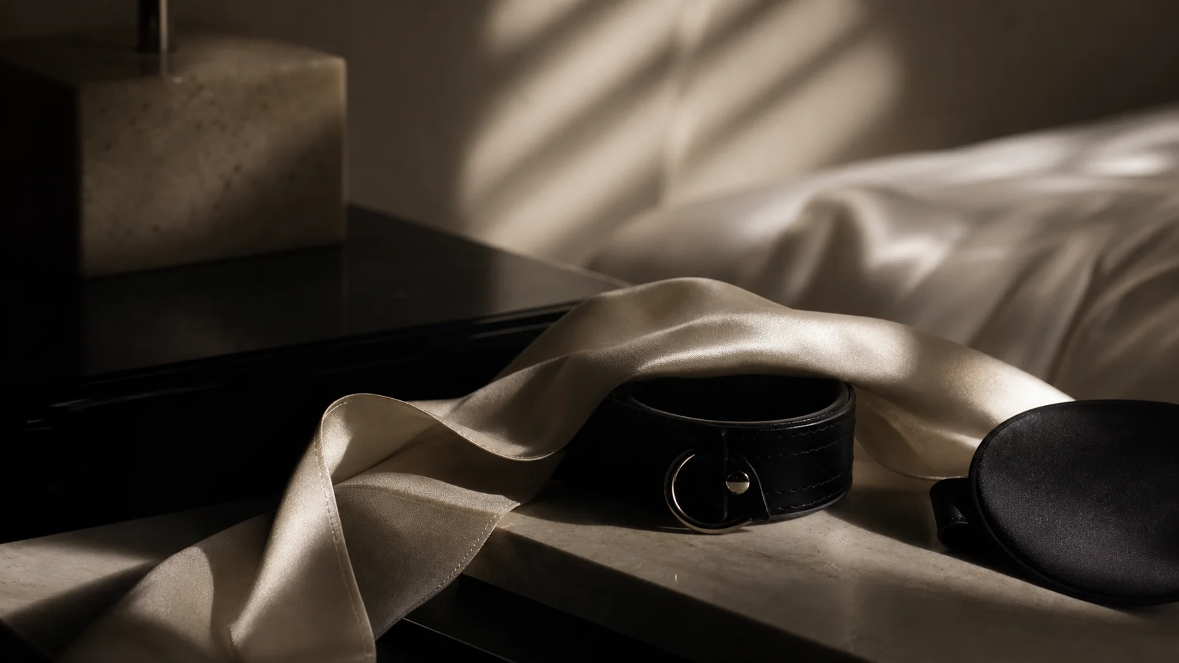 Silk ribbon and calfskin object crossing into shadow