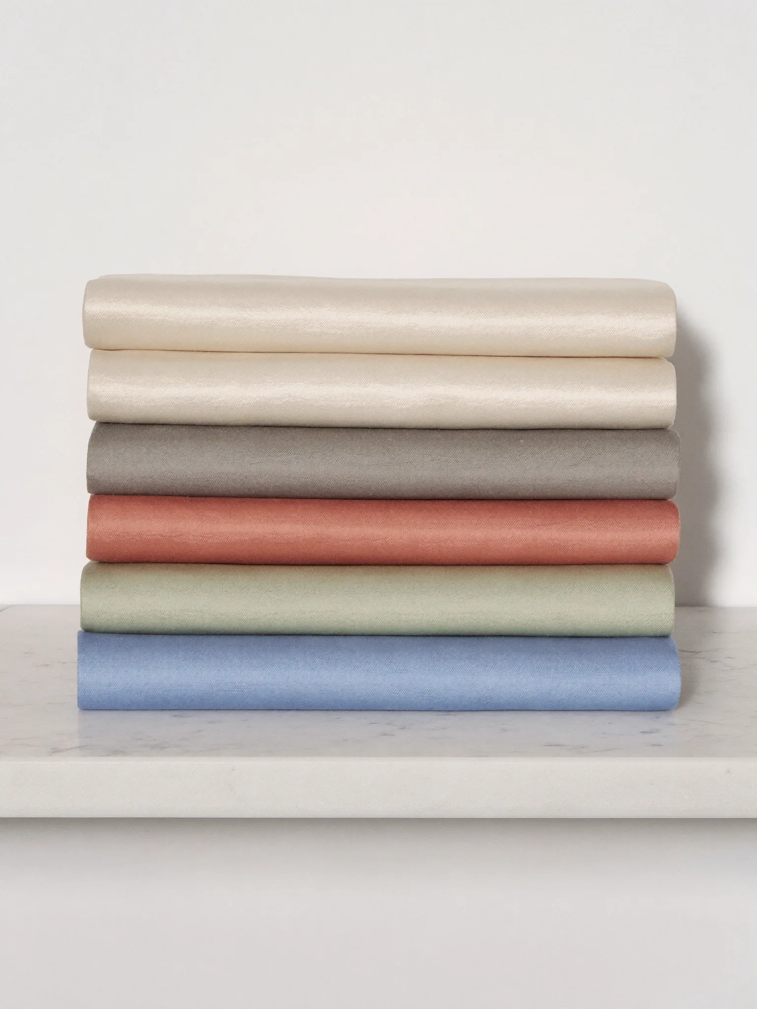 Ivory silk folded into quiet sculptural layers